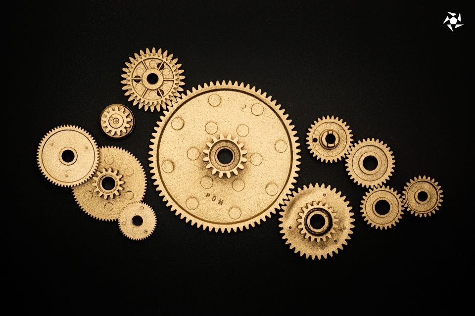 A collection of gold-colored interactive gear wheels